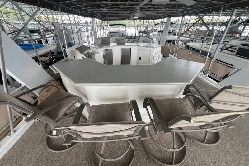 Slide: The Image of Luxurious 1999 Fantasy houseboat with spacious deck and modern bar seating area. - 16