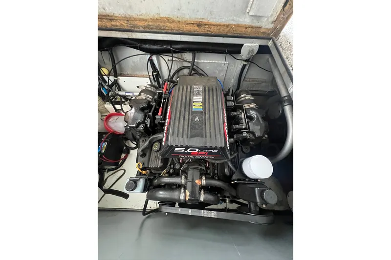 Slide: The Image of Engine compartment of a 1999 Fantasy 75' x 17' Custom boat, featuring a 5.0L V8 engine. - 52