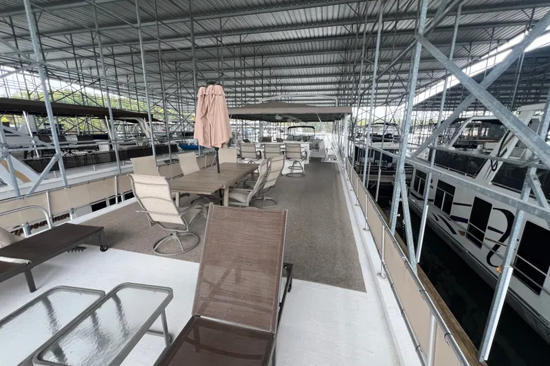 Slide: The Image of Spacious deck of a 1999 Fantasy 75' x 17' Custom houseboat in a marina. - 14