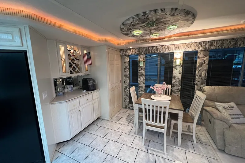 Slide: The Image of Elegant dining area in a 1999 Fantasy Custom houseboat with modern decor and ambient lighting. - 27