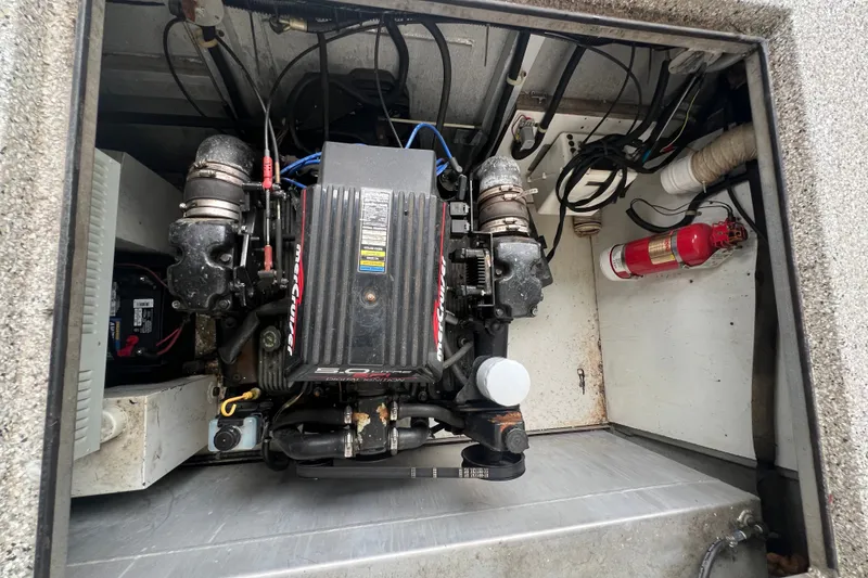 Slide: The Image of Engine compartment of a 1999 Fantasy 75' x 17' Custom boat with visible fire extinguisher. - 53