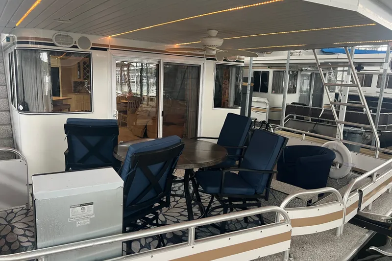 Slide: The Image of Outdoor seating area on a 1999 Fantasy 75' x 17' Custom houseboat. - 3