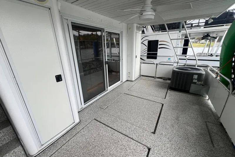 Slide: The Image of Spacious deck of 1999 Fantasy 75' x 17' Custom houseboat with sliding glass doors. - 6