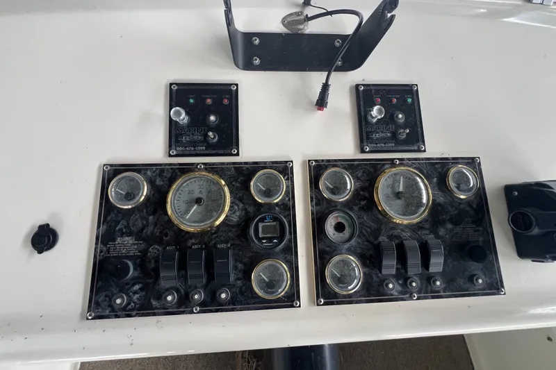 Slide: The Image of Control panel of a 1999 Fantasy 75' x 17' Custom boat with gauges and switches. - 13