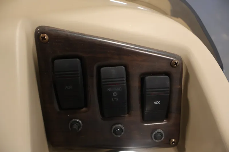 Slide: The Image of Control panel of a 2017 Bennington 21 SL boat with switches and knobs. - 21
