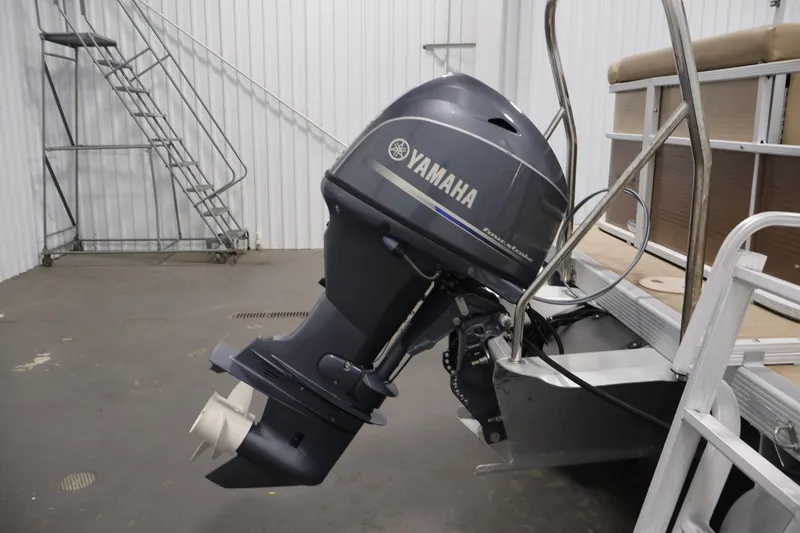 Slide: The Image of 2017 Bennington 21 SL pontoon boat with Yamaha outboard motor in a storage facility. - 31