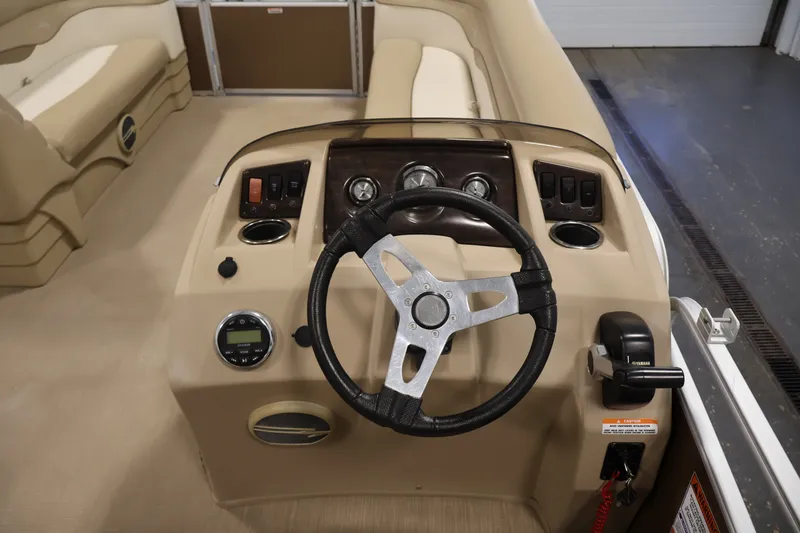 Slide: The Image of 2017 Bennington 21 SL boat dashboard with steering wheel and control panel. - 17