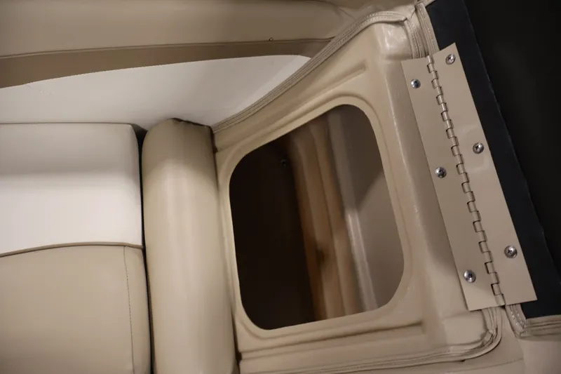 Slide: The Image of 2017 Bennington 21 SL boat interior storage compartment with beige upholstery. - 26