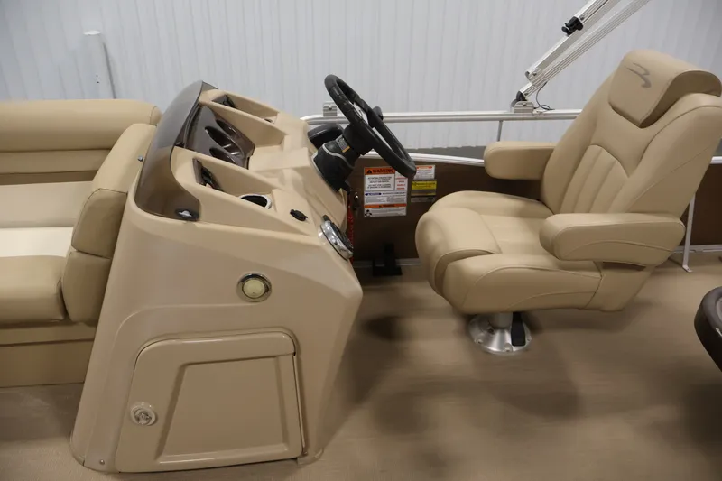 Slide: The Image of 2017 Bennington 21 SL boat interior with beige captain's chair and steering console. - 15