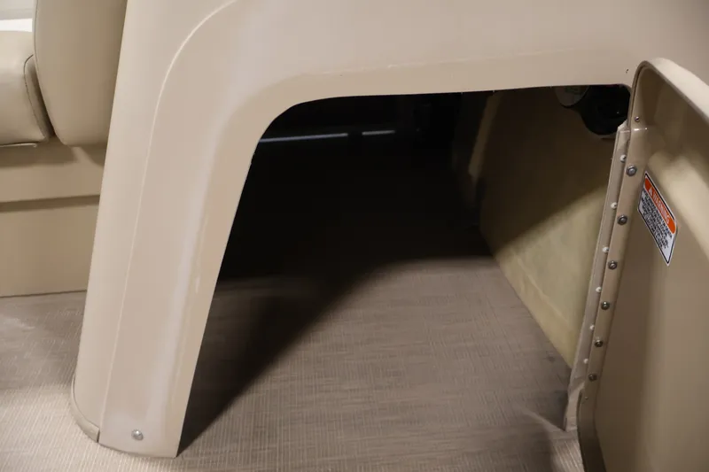 Slide: The Image of Interior view of a 2017 Bennington 21 SL boat, showcasing seating and storage area. - 16
