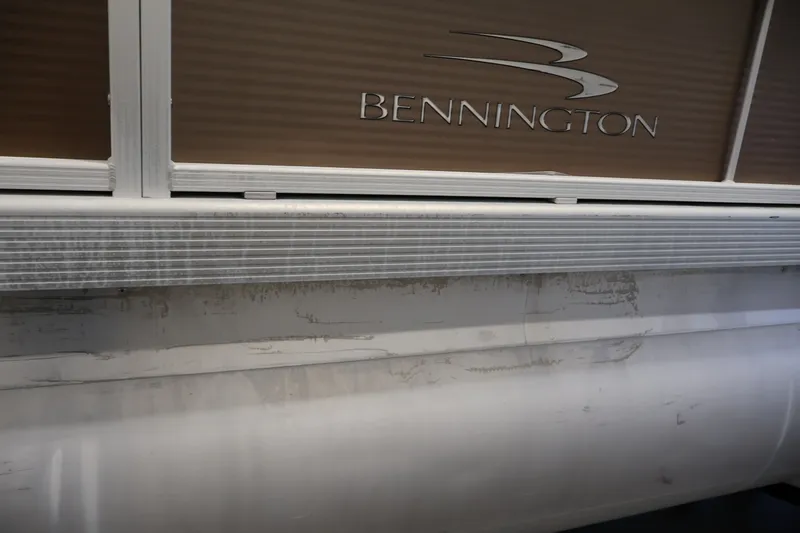 Slide: The Image of 2017 Bennington 21 SL pontoon boat exterior with logo and aluminum siding. - 38