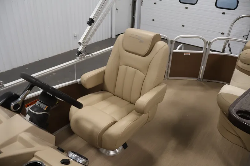 Slide: The Image of 2017 Bennington 21 SL boat interior with beige captain's chair and steering wheel. - 24
