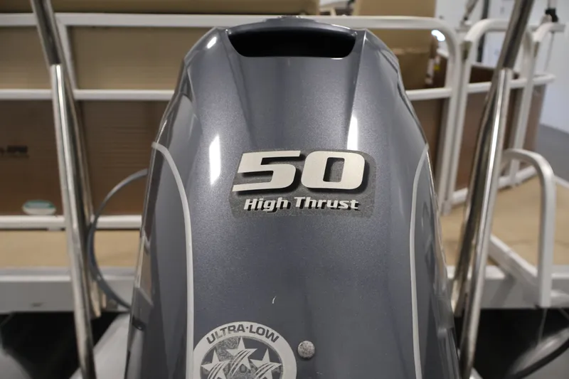 Slide: The Image of Outboard motor with "50 High Thrust" label on a 2017 Bennington 21 SL boat. - 33