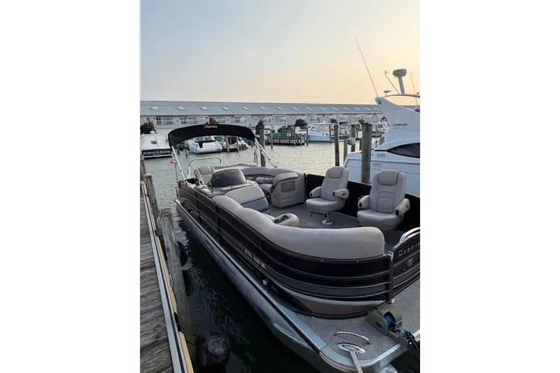 Slide: The Image of 2012 Premier 250 Grand Majestic LTD pontoon boat docked at marina. - 2