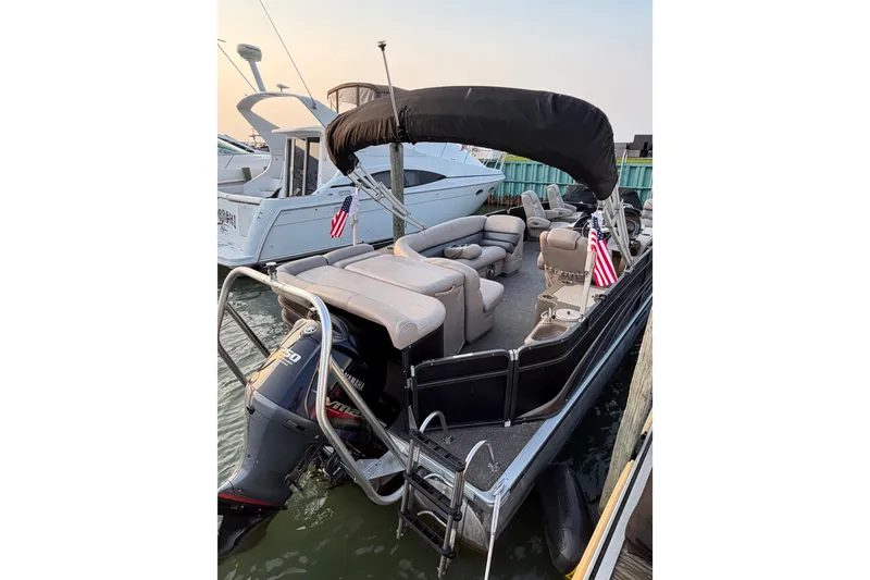 Slide: The Image of 2012 Premier 250 Grand Majestic LTD pontoon boat docked with seating and canopy. - 3