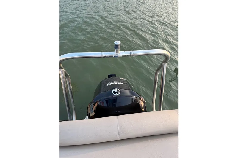 Slide: The Image of Outboard motor on a 2012 Premier 250 Grand Majestic LTD pontoon boat, viewed from the deck. - 23