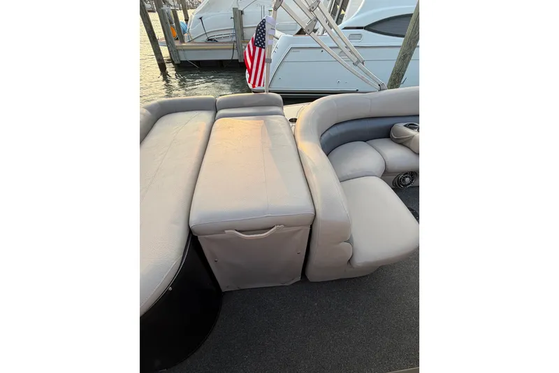 Slide: The Image of Premier 250 Grand Majestic LTD 2012 boat interior with plush seating and American flag. - 16