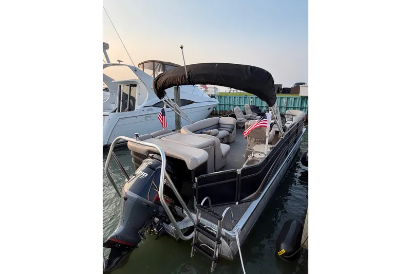 Slide: The Image of 2012 Premier 250 Grand Majestic LTD pontoon boat docked with American flags. - 4