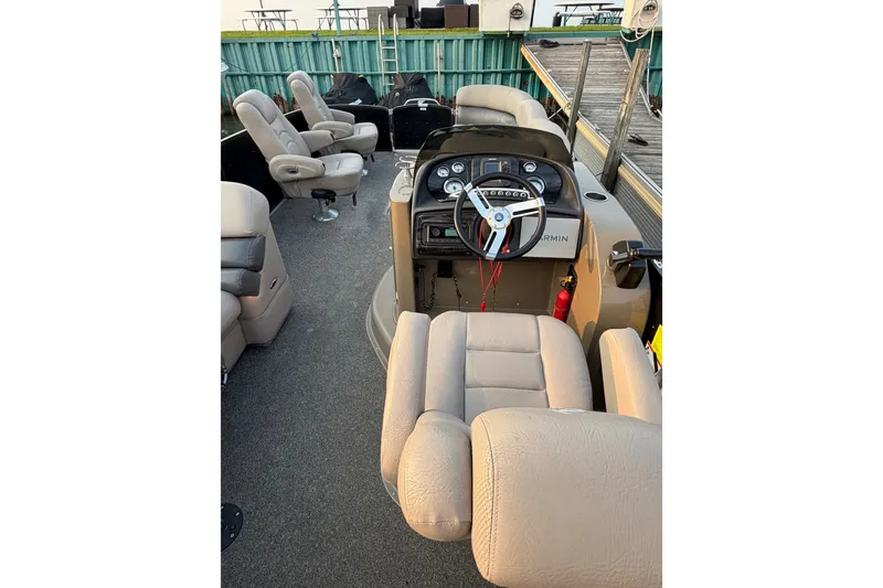 Slide: The Image of Interior of a 2012 Premier 250 Grand Majestic LTD pontoon boat with beige seating. - 10