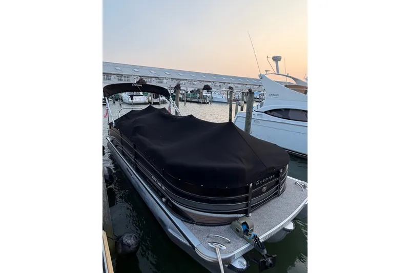 Slide: The Image of 2012 Premier 250 Grand Majestic LTD pontoon boat docked with cover at marina. - 25