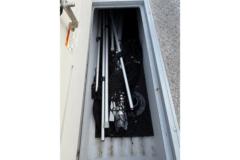 Slide: The Image of Storage compartment of a 2012 Premier 250 Grand Majestic LTD with poles and netting. - 8