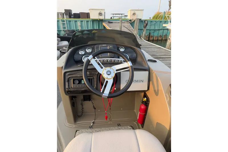 Slide: The Image of Steering console of 2012 Premier 250 Grand Majestic LTD boat with Garmin system. - 15