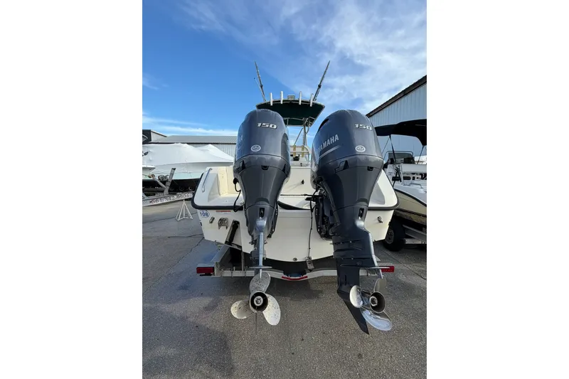 Slide: The Image of 2001 Pursuit 2470 Center Console boat with dual Yamaha 150 engines. - 18
