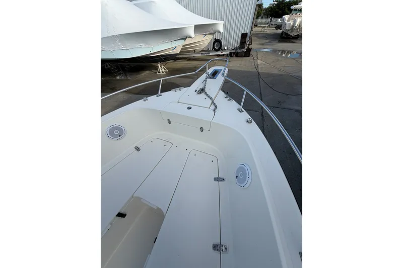 Slide: The Image of 2001 Pursuit 2470 Center Console boat deck, docked with visible anchor chain. - 9