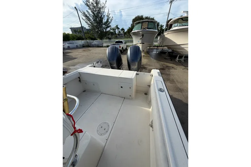 Slide: The Image of 2001 Pursuit 2470 Center Console boat with dual outboard motors in a marina setting. - 14