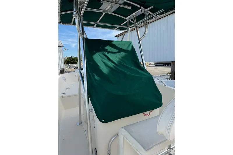 Slide: The Image of 2001 Pursuit 2470 Center Console boat with green cover and T-top. - 5