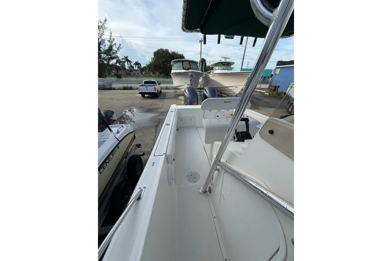 Slide: The Image of 2001 Pursuit 2470 Center Console boat, docked with other vessels in a marina. - 11