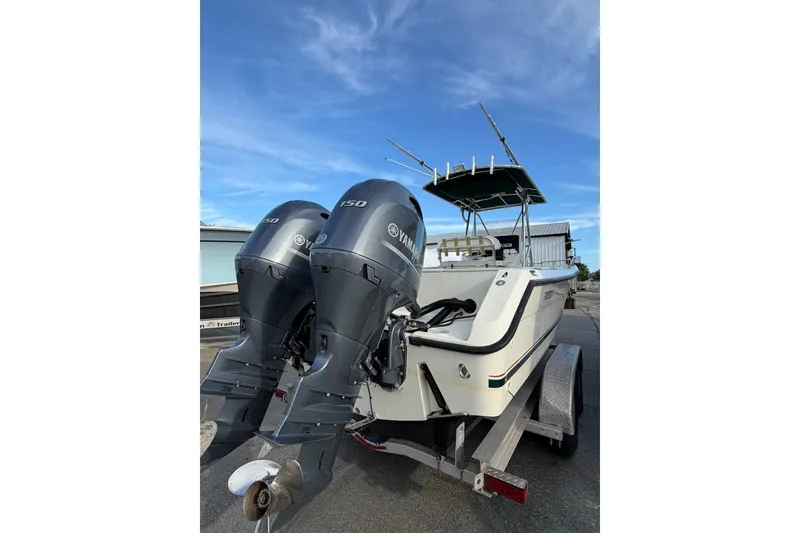 Slide: The Image of 2001 Pursuit 2470 Center Console boat with dual Yamaha 150 engines on trailer. - 19