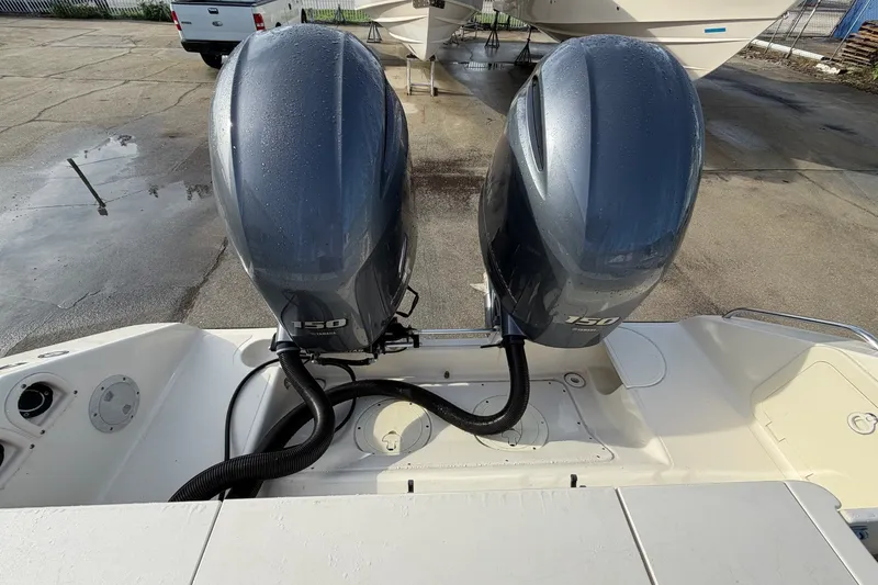 Slide: The Image of Twin 150 horsepower engines on a 2001 Pursuit 2470 Center Console boat. - 17