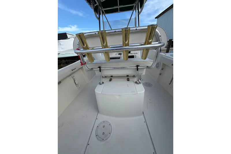 Slide: The Image of 2001 Pursuit 2470 Center Console boat interior with rod holders and storage compartment. - 15