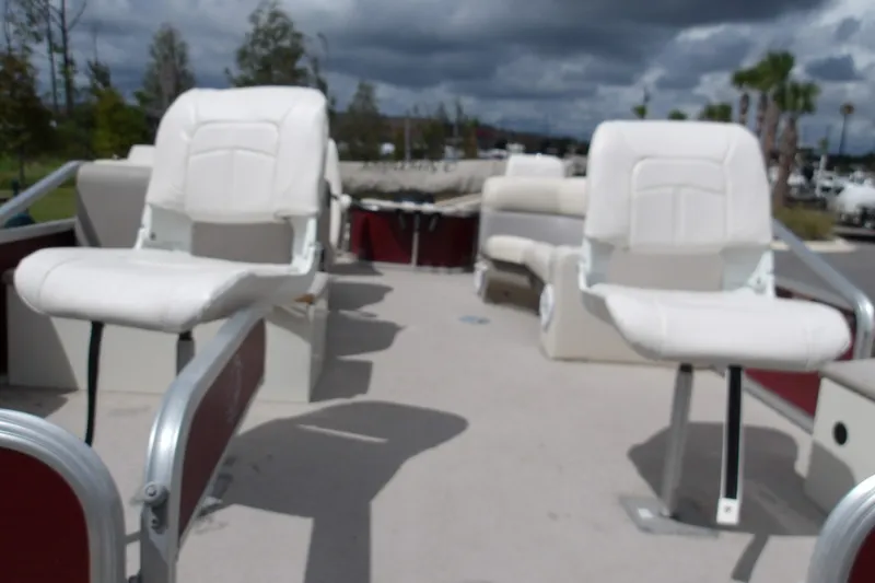 Slide: The Image of 2010 Lowe SF 194 Sport Fish boat with white seating and overcast sky. - 3