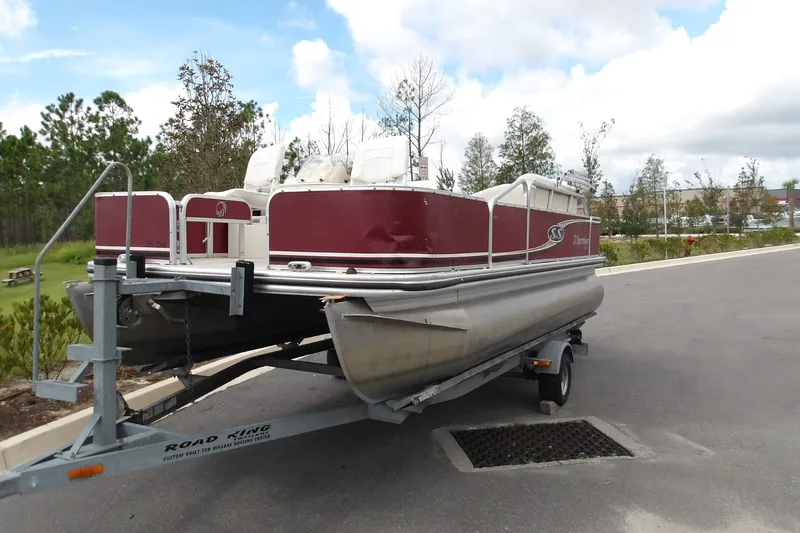 Slide: The Image of 2010 Lowe SF 194 Sport Fish pontoon boat on trailer, parked outdoors. - 7