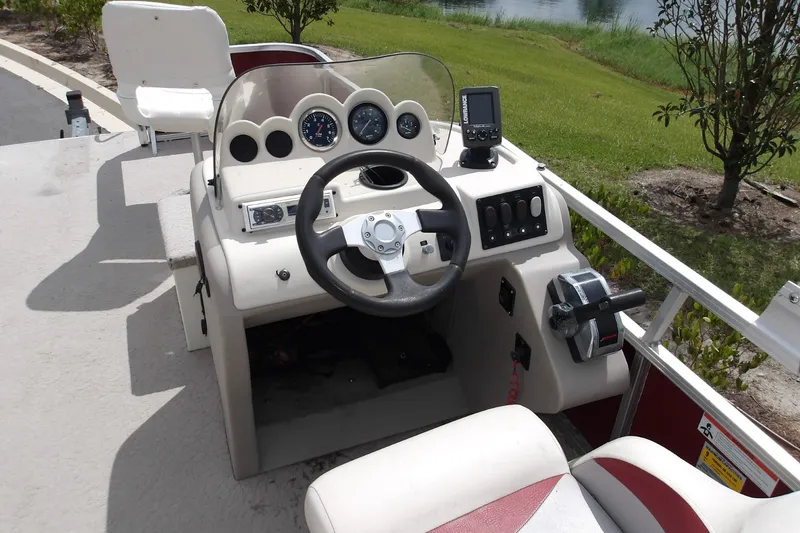 Slide: The Image of 2010 Lowe SF 194 Sport Fish boat console with steering wheel and control panel. - 2