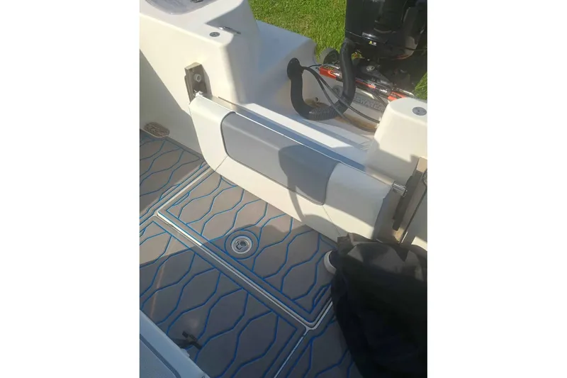 Slide: The Image of 2019 Tidewater 210 CC Adventure boat interior with patterned flooring and seating. - 6