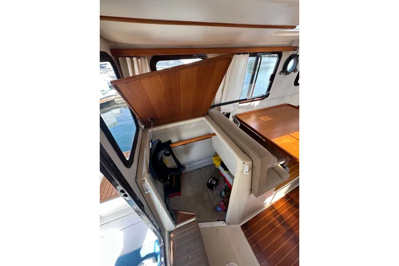 Slide: The Image of Interior of 2009 Ranger Tugs R-25 boat with open storage compartment. - 32