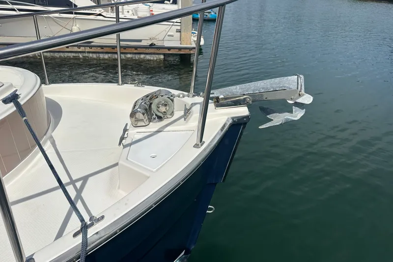 Slide: The Image of 2009 Ranger Tugs R-25 boat bow with anchor and railing in marina. - 10