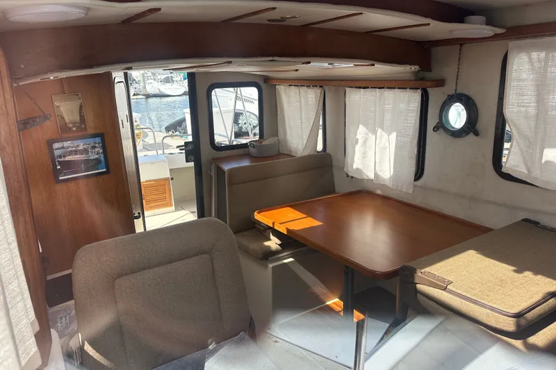 Slide: The Image of Interior of 2009 Ranger Tugs R-25 boat with dining area and windows. - 12