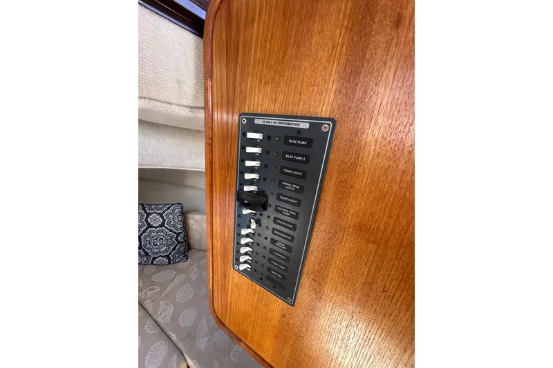 Slide: The Image of 2009 Ranger Tugs R-25 interior electrical panel with switches on wooden surface. - 29
