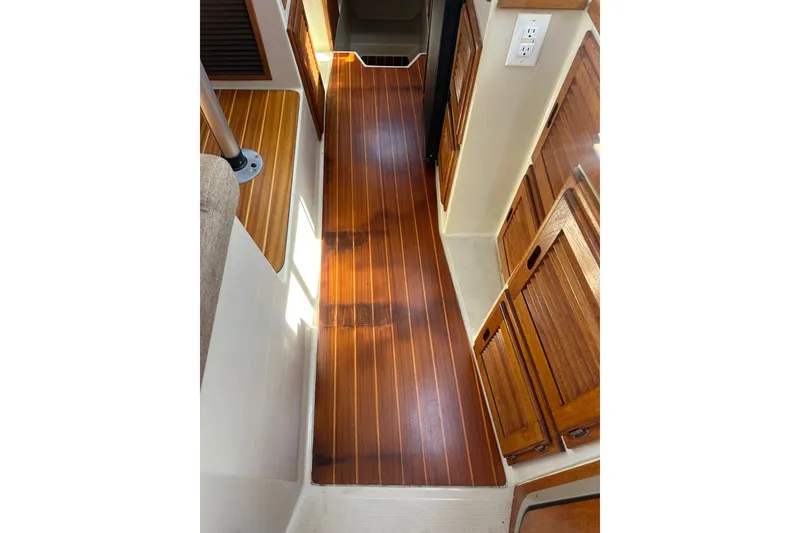 Slide: The Image of Interior view of 2009 Ranger Tugs R-25 with polished wooden flooring. - 33