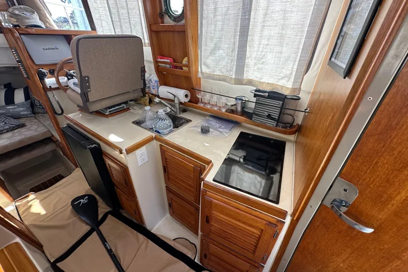 Slide: The Image of Interior of 2009 Ranger Tugs R-25 boat with kitchenette and steering area. - 20