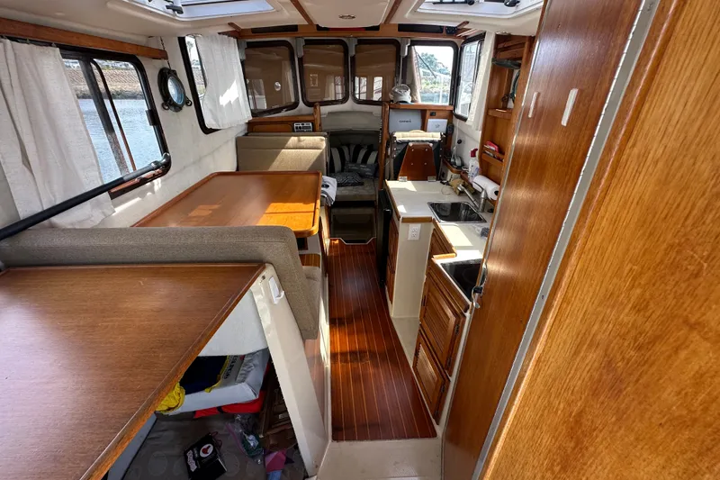 Slide: The Image of Interior of 2009 Ranger Tugs R-25 boat with wood finishes and compact kitchen. - 31