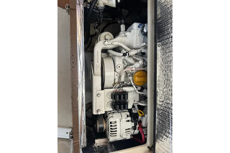 Slide: The Image of Engine compartment of a 2009 Ranger Tugs R-25 boat, showcasing mechanical components. - 36