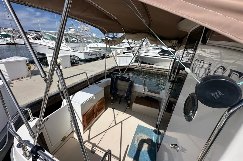 Slide: The Image of 2009 Ranger Tugs R-25 boat docked at marina, featuring spacious deck and canopy. - 15
