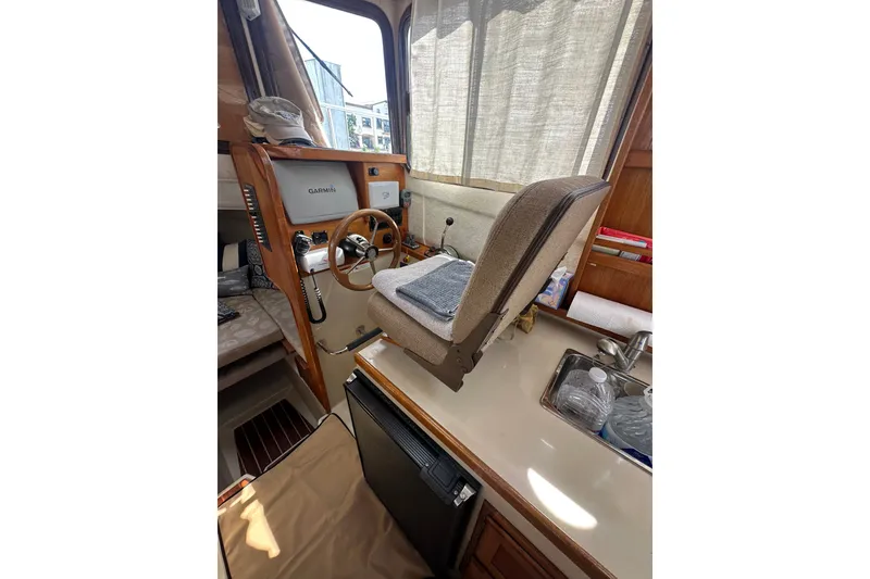 Slide: The Image of Interior of 2009 Ranger Tugs R-25 boat with helm, Garmin display, and kitchenette. - 22