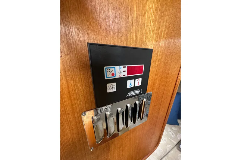 Slide: The Image of Control panel on 2009 Ranger Tugs R-25 boat with wooden finish and metallic accents. - 28