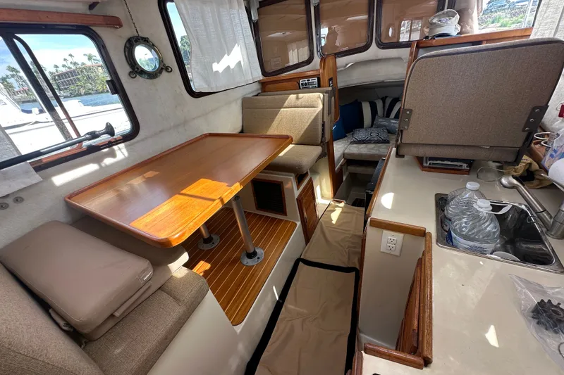 Slide: The Image of Interior of 2009 Ranger Tugs R-25 boat with dining area and kitchenette. - 21